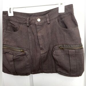 Army green in the light , dark brown with out the light never worn mini skirt